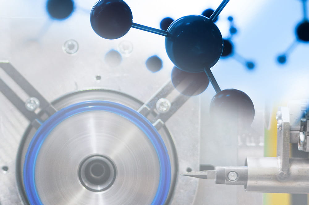 A rotating machine part in steel with a glowing blue outline is combined with a 3D molecular structure, illustrating technology and science synergy.